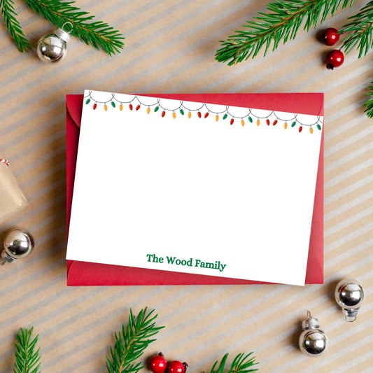 custom Christmas stationery with a family's name and twinkling lights