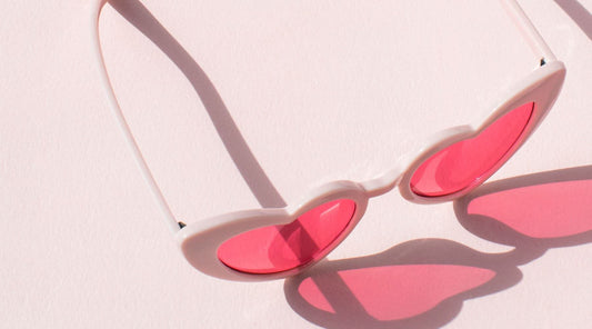 red heart sunglasses on a pink background